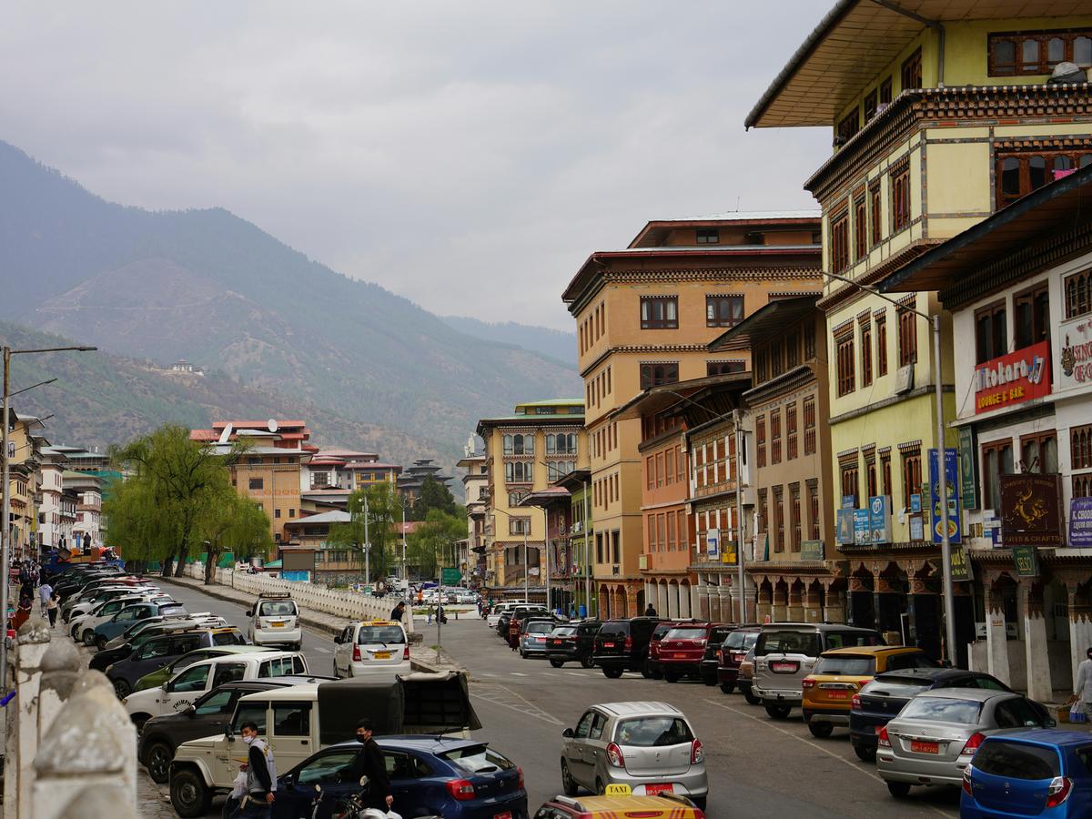 A city street in Bhutan with buildings and cars