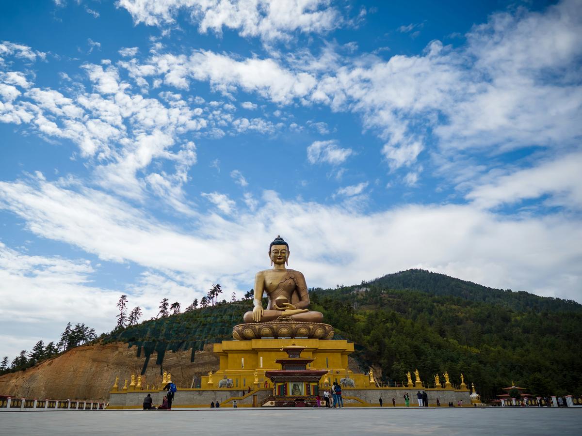 Golden Buddha Dordenma statue against a blue sky