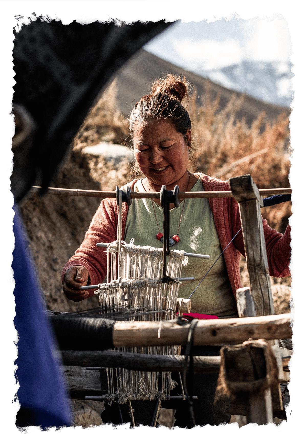 a woman weaving in a community setting.